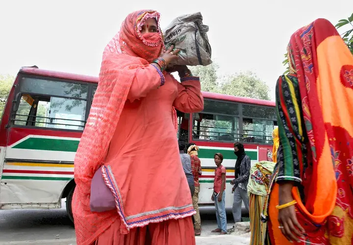 Women in India with bus in background 